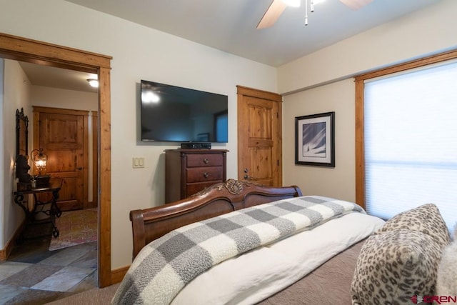 bedroom featuring baseboards and ceiling fan