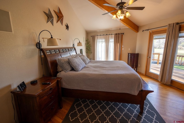 bedroom featuring ceiling fan, vaulted ceiling with beams, access to outside, and wood finished floors