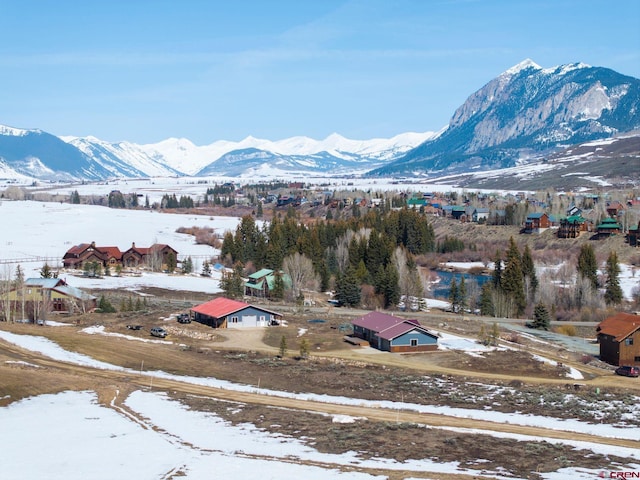 snowy aerial view featuring a mountain view