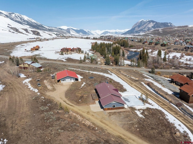 snowy aerial view with a mountain view