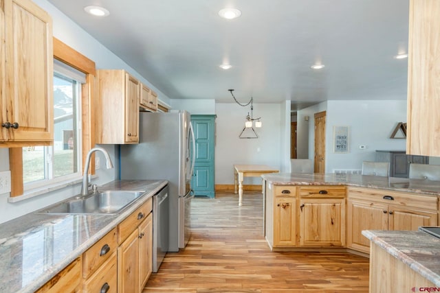 kitchen with a sink and light brown cabinets
