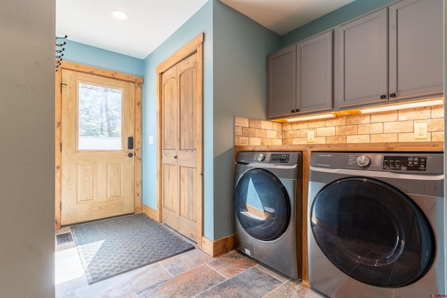 561 Sierra Dr, Durango, CO 81301 - laundry area with washing machine and clothes dryer, cabinet space, stone finish floor, baseboards, and visible vents