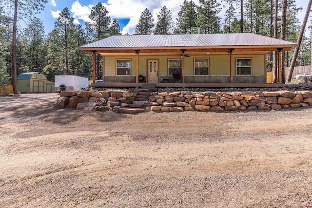 561 Sierra Dr, Durango, CO 81301 - back of house featuring a storage shed, an outdoor structure, a porch, and metal roof