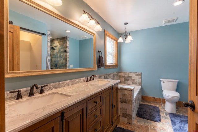 561 Sierra Dr, Durango, CO 81301 - bathroom with toilet, visible vents, a sink, and tiled tub