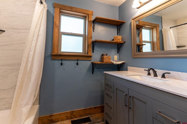 561 Sierra Dr, Durango, CO 81301 - full bath featuring vanity, baseboards, shower / bath combo, and visible vents