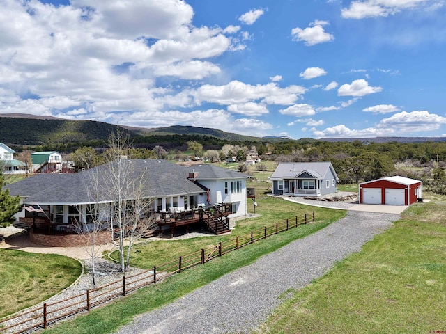 22876 Thunder Mountain Ln, Cedaredge, CO 81413 - ranch-style home featuring driveway, a front yard, fence private yard, a detached garage, and an outdoor structure