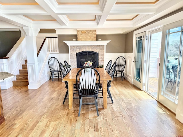 22876 Thunder Mountain Ln, Cedaredge, CO 81413 - dining room featuring a decorative wall, a fireplace, stairway, beamed ceiling, and coffered ceiling