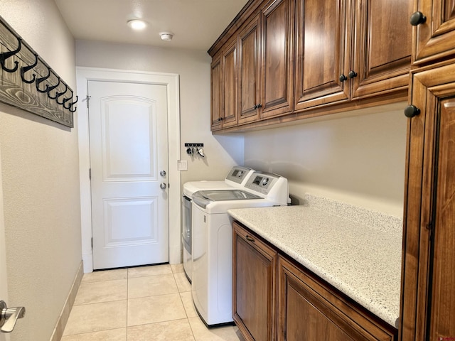 22876 Thunder Mountain Ln, Cedaredge, CO 81413 - washroom featuring light tile patterned floors, baseboards, cabinet space, and washer and dryer