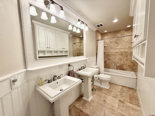 22876 Thunder Mountain Ln, Cedaredge, CO 81413 - full bath with shower / bath combination with curtain, visible vents, wainscoting, a sink, and toilet