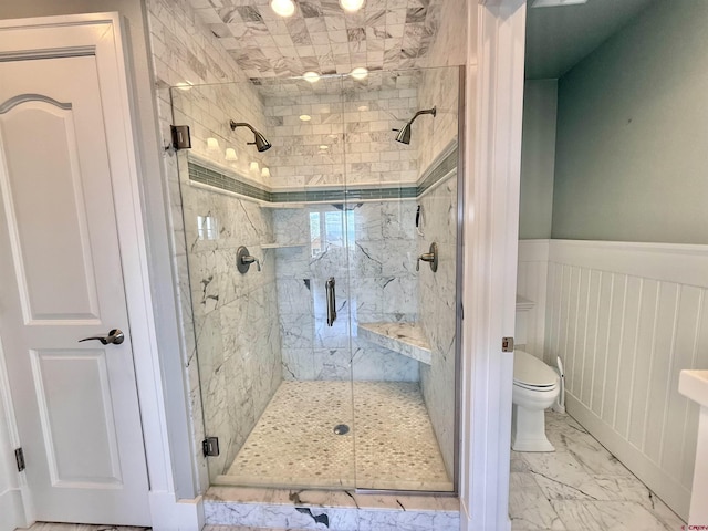 22876 Thunder Mountain Ln, Cedaredge, CO 81413 - full bathroom featuring toilet, wainscoting, a shower stall, and marble finish floor