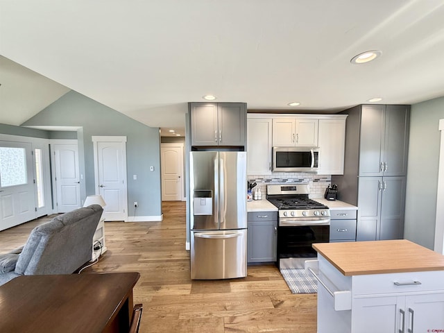 22876 Thunder Mountain Ln, Cedaredge, CO 81413 - kitchen featuring open floor plan, light countertops, appliances with stainless steel finishes, backsplash, and gray cabinetry