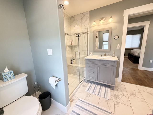 22876 Thunder Mountain Ln, Cedaredge, CO 81413 - bathroom with a stall shower, vanity, baseboards, toilet, and marble finish floor