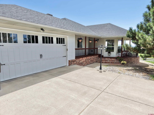 22876 Thunder Mountain Ln, Cedaredge, CO 81413 - ranch-style home with a porch, concrete driveway, a shingled roof, and a garage