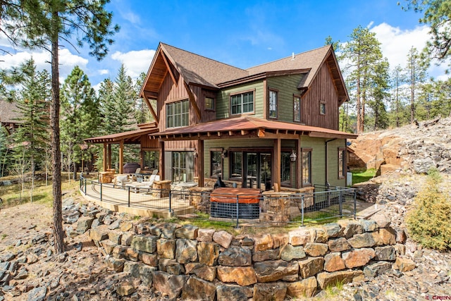 rear view of house with a patio and a shingled roof