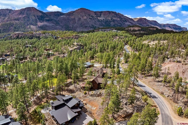 drone / aerial view featuring a forest view and a mountain view