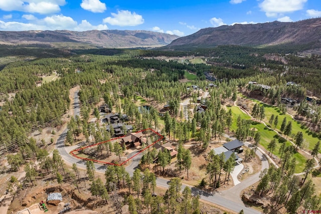 drone / aerial view featuring a view of trees and a mountain view