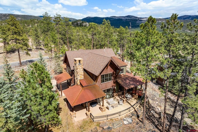 bird's eye view featuring a forest view and a mountain view
