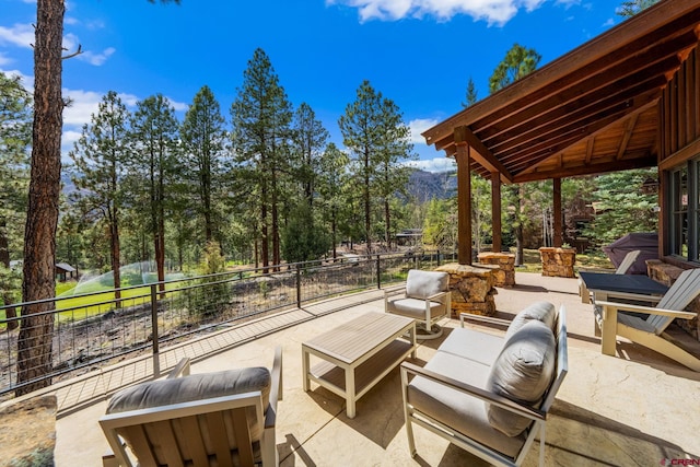 view of patio / terrace with an outdoor living space and fence