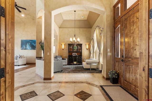 714 Washington Ct, Grand Junction, CO 81507 - foyer featuring arched walkways, a chandelier, high vaulted ceiling, ceiling fan, and baseboards