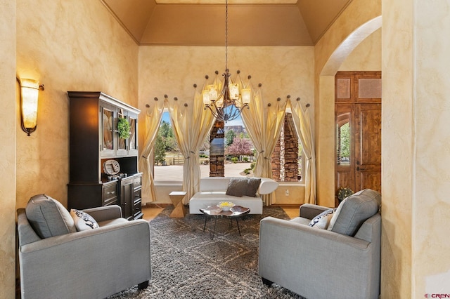 714 Washington Ct, Grand Junction, CO 81507 - living area with a chandelier, a high ceiling, arched walkways, and a textured wall