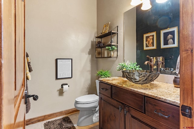 714 Washington Ct, Grand Junction, CO 81507 - half bath featuring tile patterned floors, toilet, vanity, and baseboards