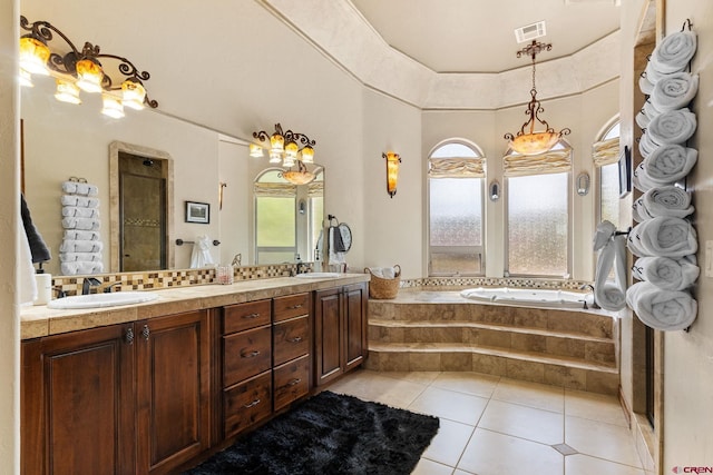714 Washington Ct, Grand Junction, CO 81507 - full bathroom featuring double vanity, a garden tub, tile patterned floors, and a towering ceiling