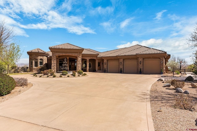 714 Washington Ct, Grand Junction, CO 81507 - mediterranean / spanish house with curved driveway, a tiled roof, stone siding, a garage, and stucco siding