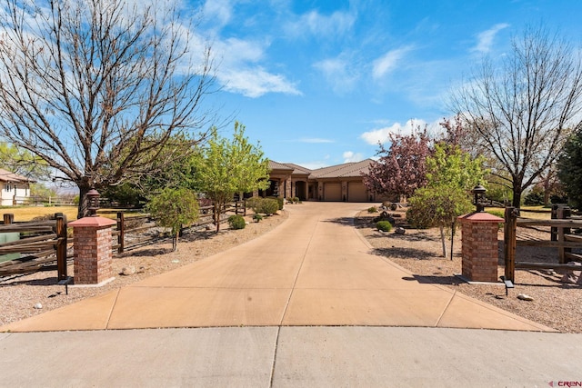 714 Washington Ct, Grand Junction, CO 81507 - view of property hidden behind natural elements featuring a garage, concrete driveway, and fence