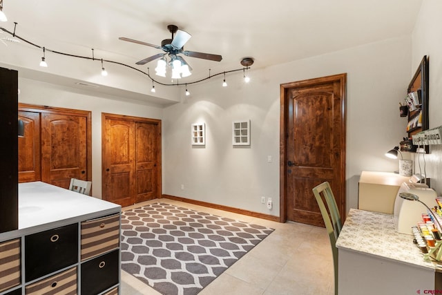714 Washington Ct, Grand Junction, CO 81507 - bedroom with track lighting, light tile patterned floors, baseboards, multiple closets, and a ceiling fan