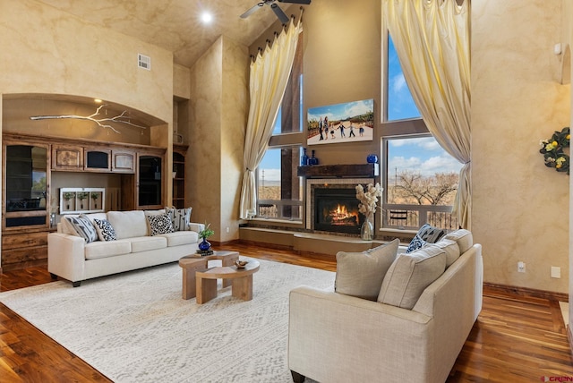 714 Washington Ct, Grand Junction, CO 81507 - living area with a towering ceiling, wood finished floors, a lit fireplace, and baseboards