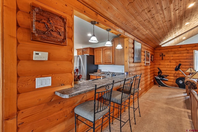 kitchen with brown cabinetry, rustic walls, lofted ceiling, light carpet, and stainless steel refrigerator with ice dispenser