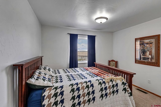 bedroom featuring visible vents, baseboards, and carpet floors