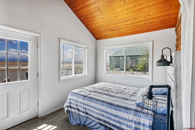 bedroom with baseboards, lofted ceiling, and wooden ceiling