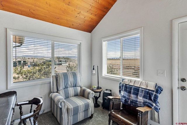 sitting room with wooden ceiling, carpet floors, baseboards, and vaulted ceiling