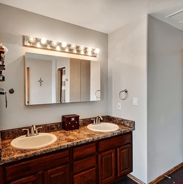 full bathroom with double vanity, a sink, and visible vents