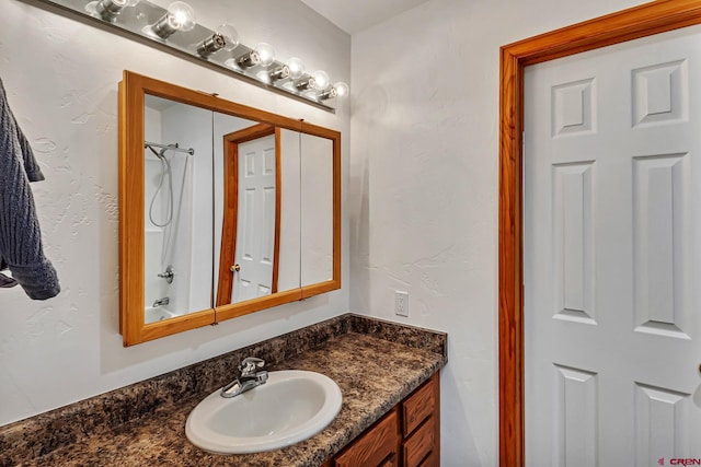 bathroom with vanity and bathing tub / shower combination