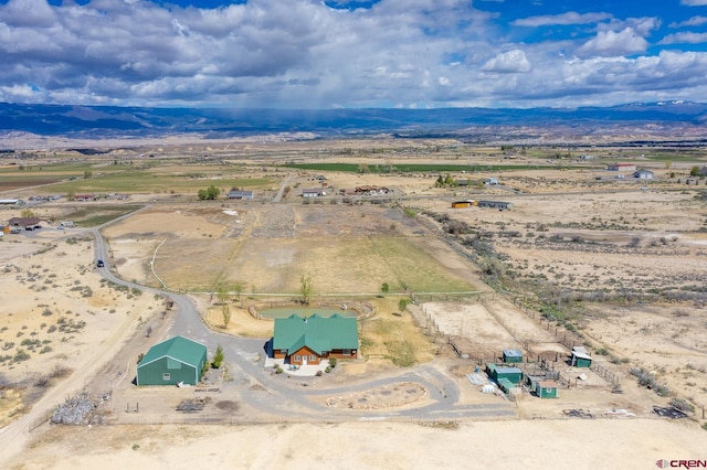 drone / aerial view featuring a mountain view and a rural view