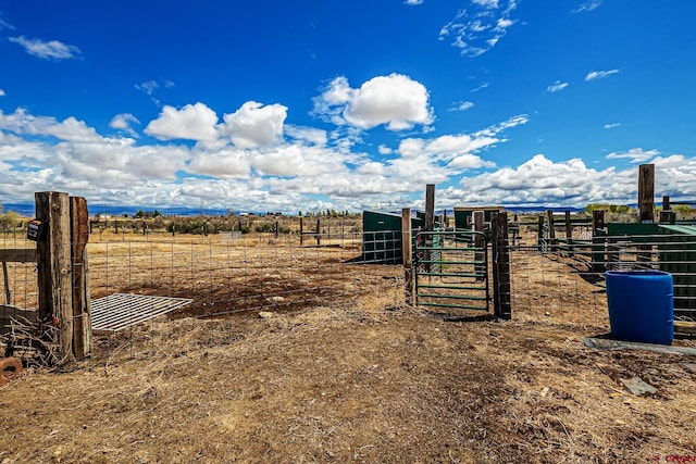 view of yard featuring fence and a rural view