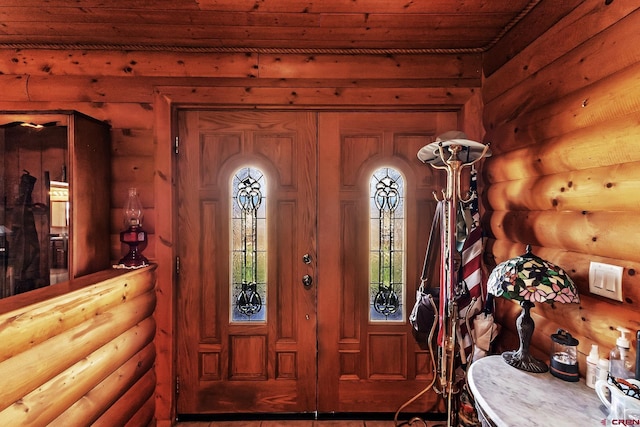entryway featuring rustic walls and wooden ceiling