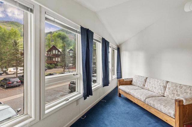 living room featuring carpet and lofted ceiling