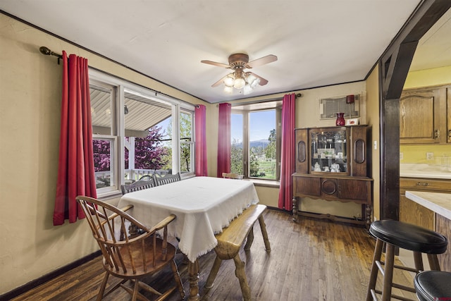 dining room with ceiling fan, dark wood finished floors, and baseboards