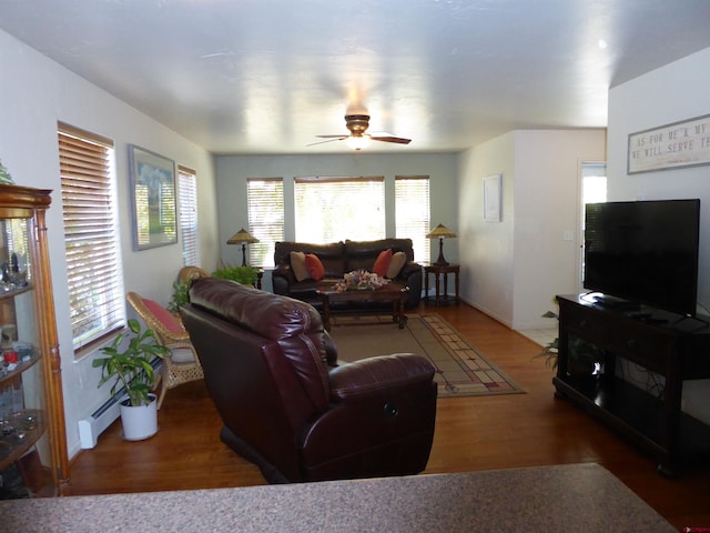 living room featuring a wealth of natural light, baseboards, a ceiling fan, and wood finished floors