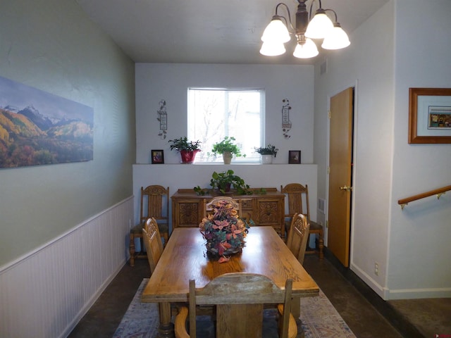 dining space with an inviting chandelier, visible vents, and concrete flooring