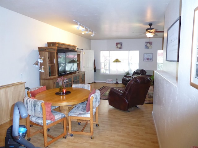dining area featuring baseboards, a ceiling fan, track lighting, and light wood-style floors