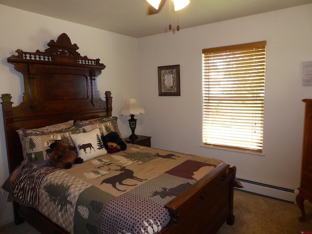 bedroom featuring a baseboard heating unit, carpet flooring, and a ceiling fan