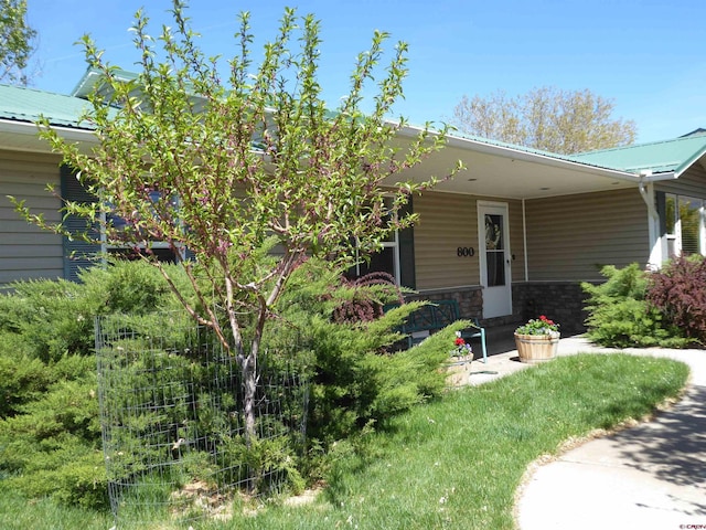view of front of home featuring covered porch and metal roof
