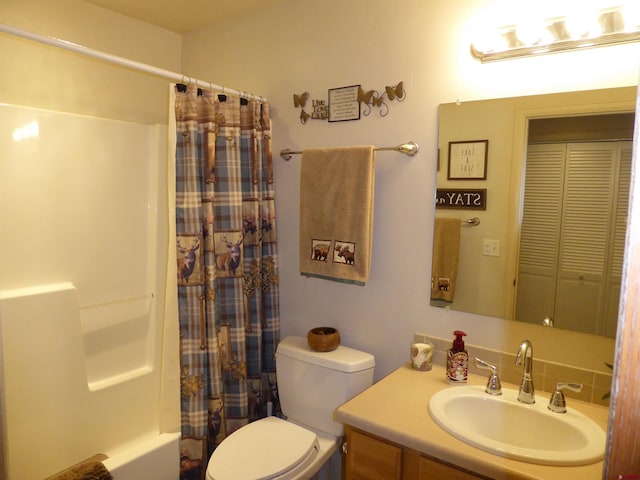bathroom with shower / bath combination with curtain, toilet, and vanity