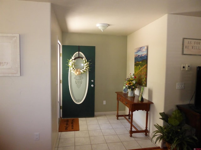 foyer with light tile patterned floors and baseboards