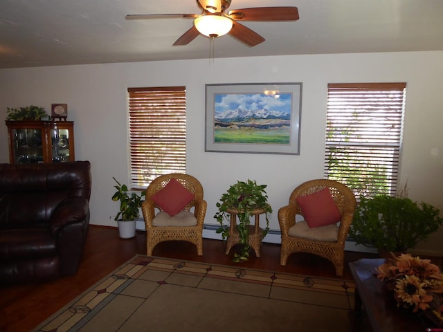 sitting room featuring a ceiling fan, a healthy amount of sunlight, and wood finished floors