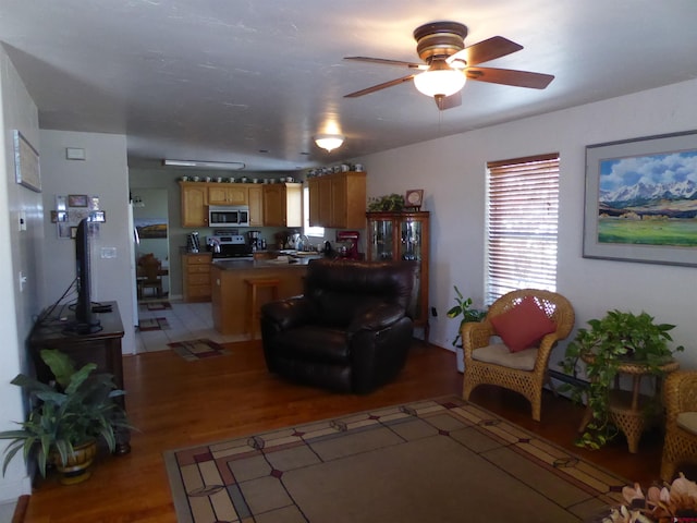 living room with light wood-style floors and ceiling fan